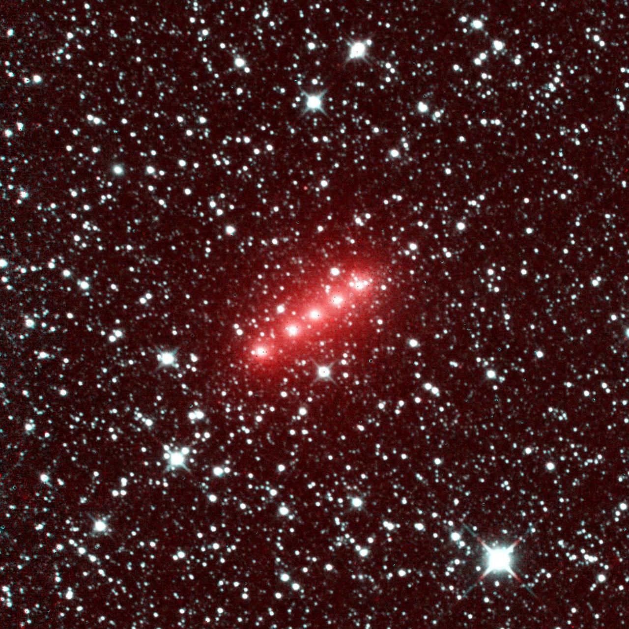 Comet NEOWISE glowing above Earth's atmosphere — photographed by an astronaut from the International Space Station, July 2020