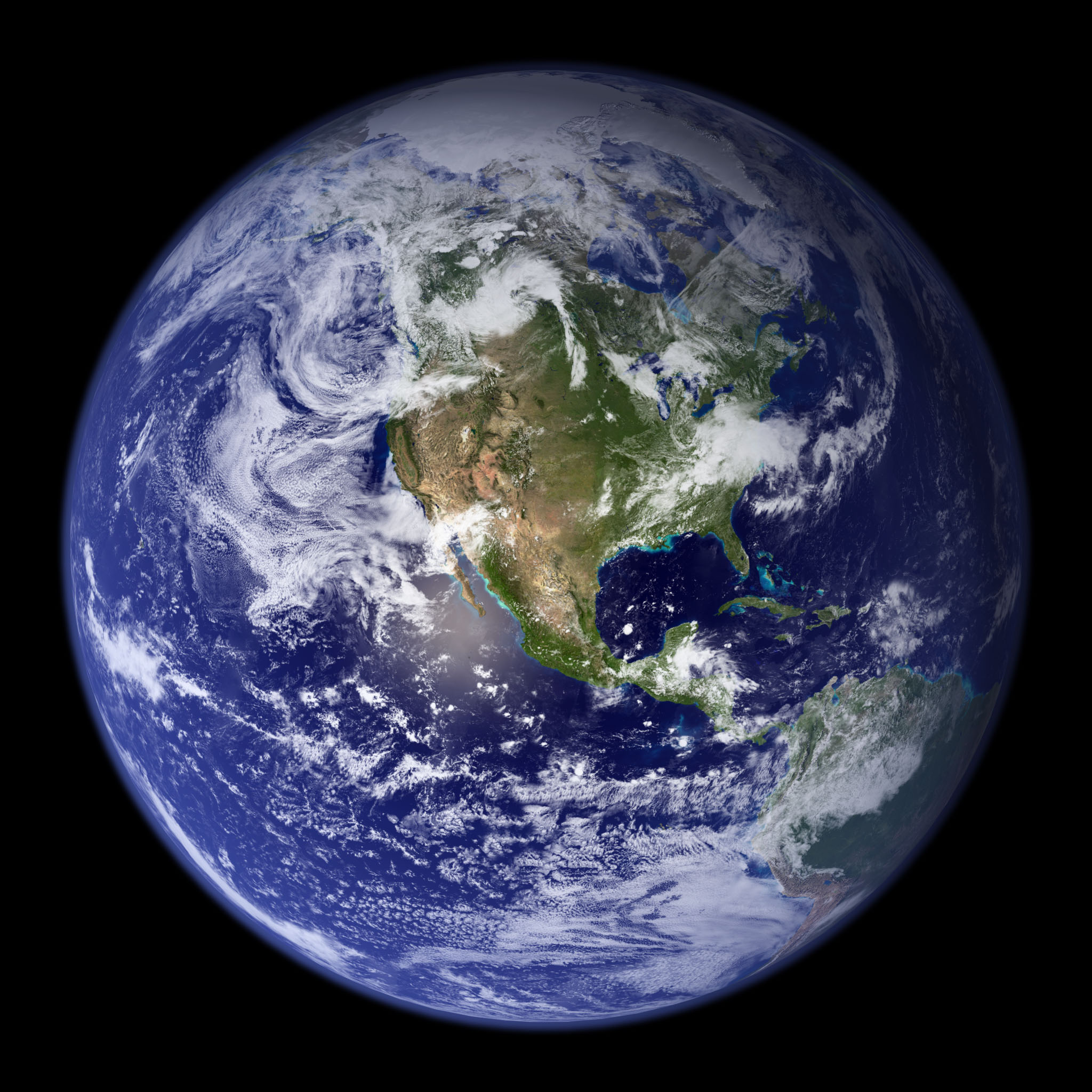 Earth — the Blue Marble, our home planet seen from space, showing the Americas, blue oceans, and white cloud swirls