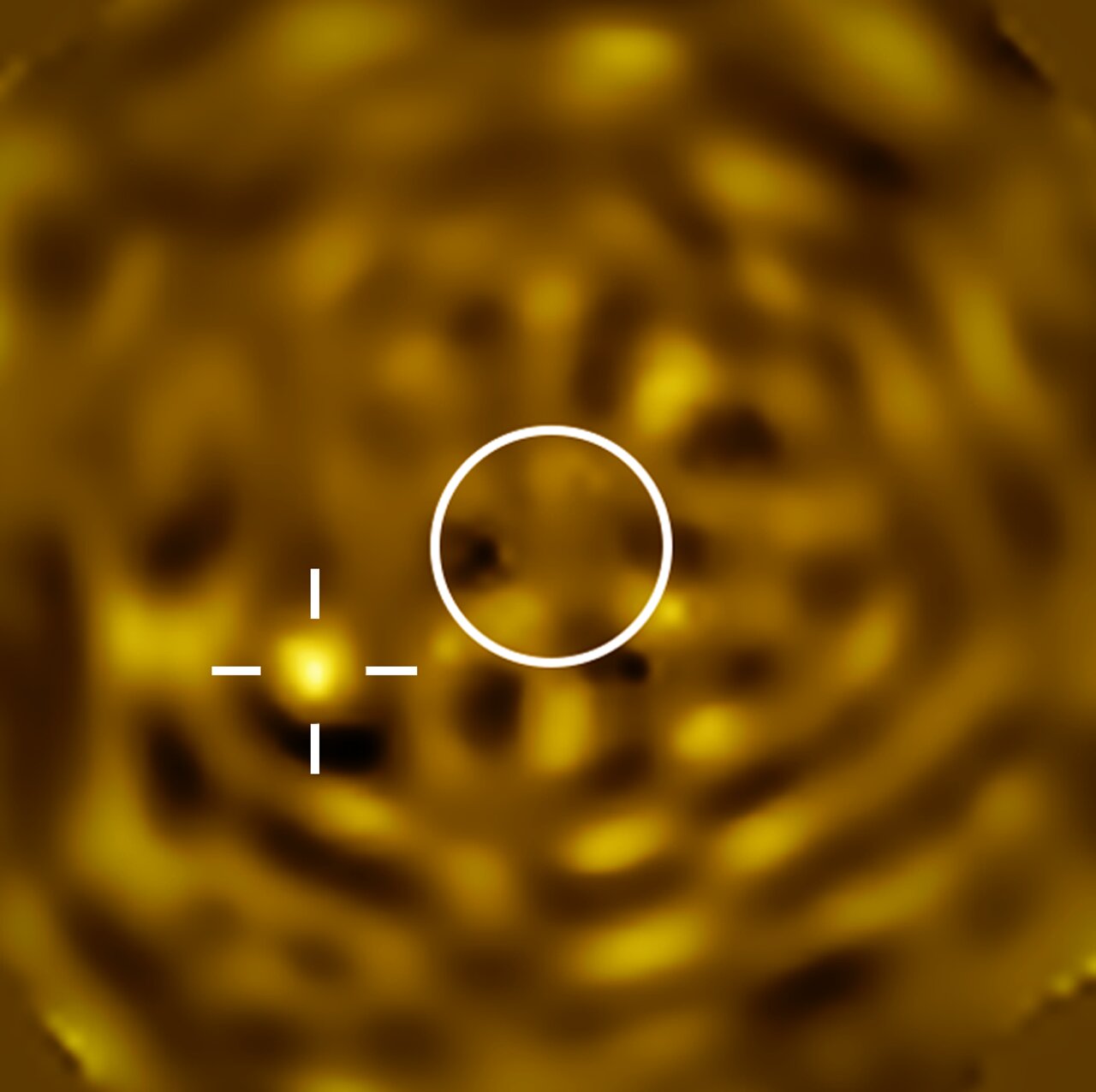 VLT image of Betelgeuse's companion — a noisy astronomical image with a bright object toward the lower-left, and a white circle at centre showing the size of Betelgeuse which has been removed to reveal the faint companion
