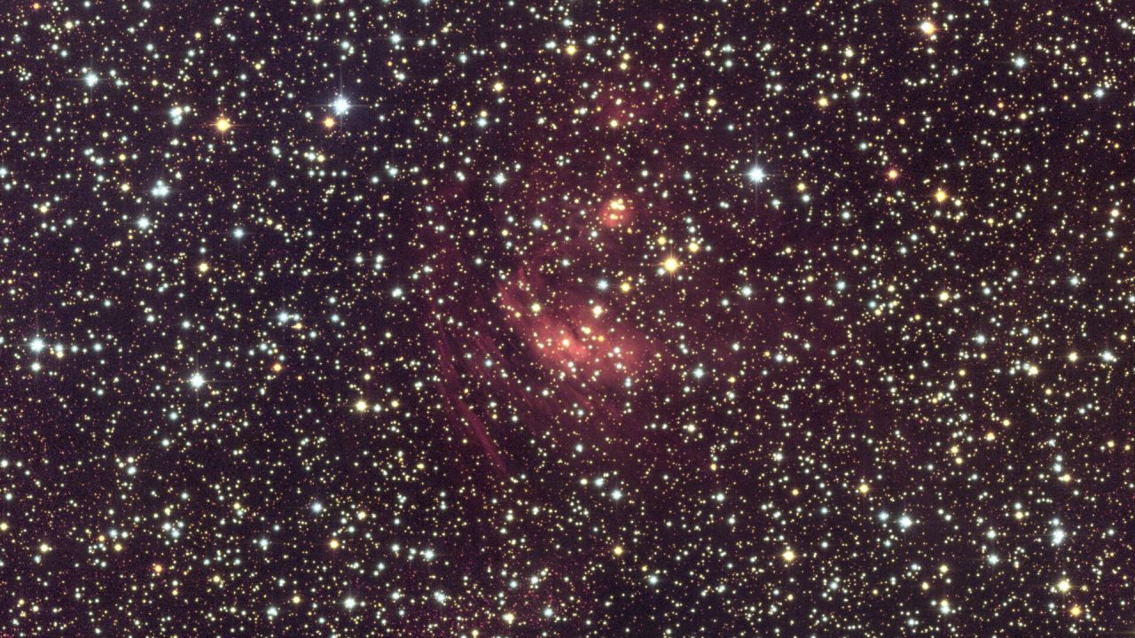 Euclid close-up of a nebula in the Milky Way's galactic bulge — glowing ionised gas and dark dust lanes illuminated by young hot stars embedded in the dense star fields near the Galactic Centre, captured at Hubble-quality resolution by Euclid's VIS camera in March 2025