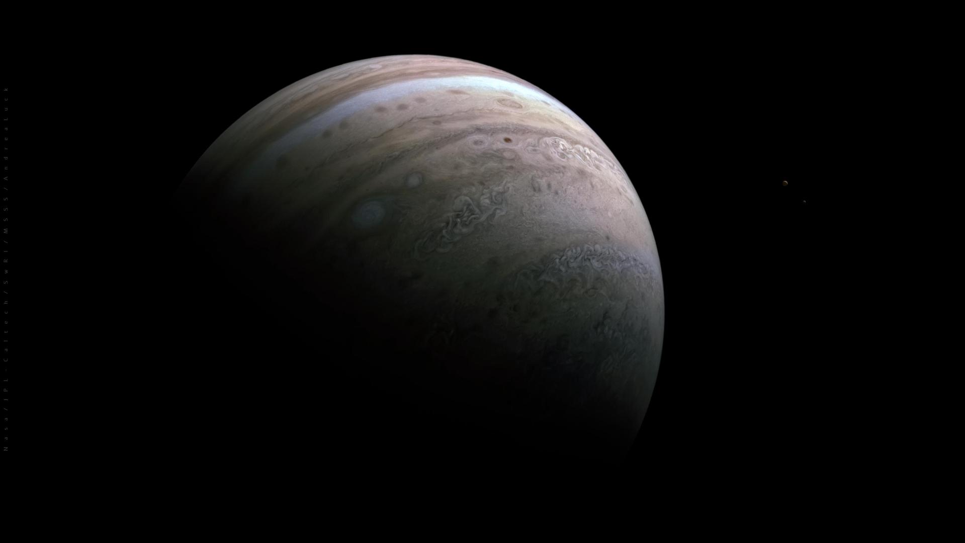 NASA Juno spacecraft image of Jupiter with moons Io and Europa nearby against black space