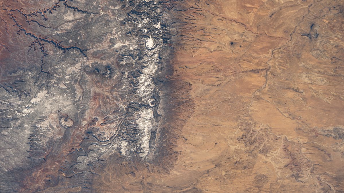 The Chuska Mountains of the Navajo Nation in north-western New Mexico, a snow-dusted ridge between red desert plateaus, photographed from the International Space Station