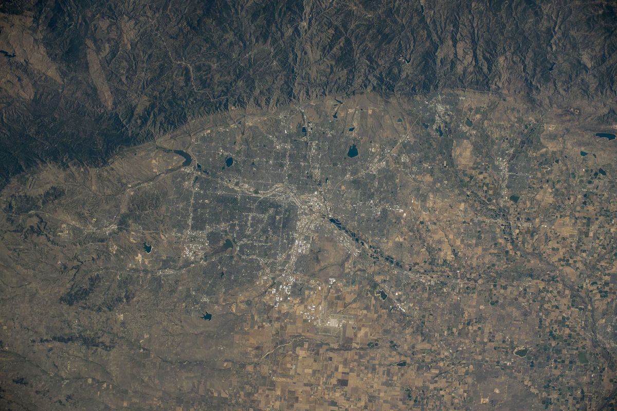 Denver and the Front Range from the International Space Station by day, the city on the plains with the foothills and Continental Divide to the west
