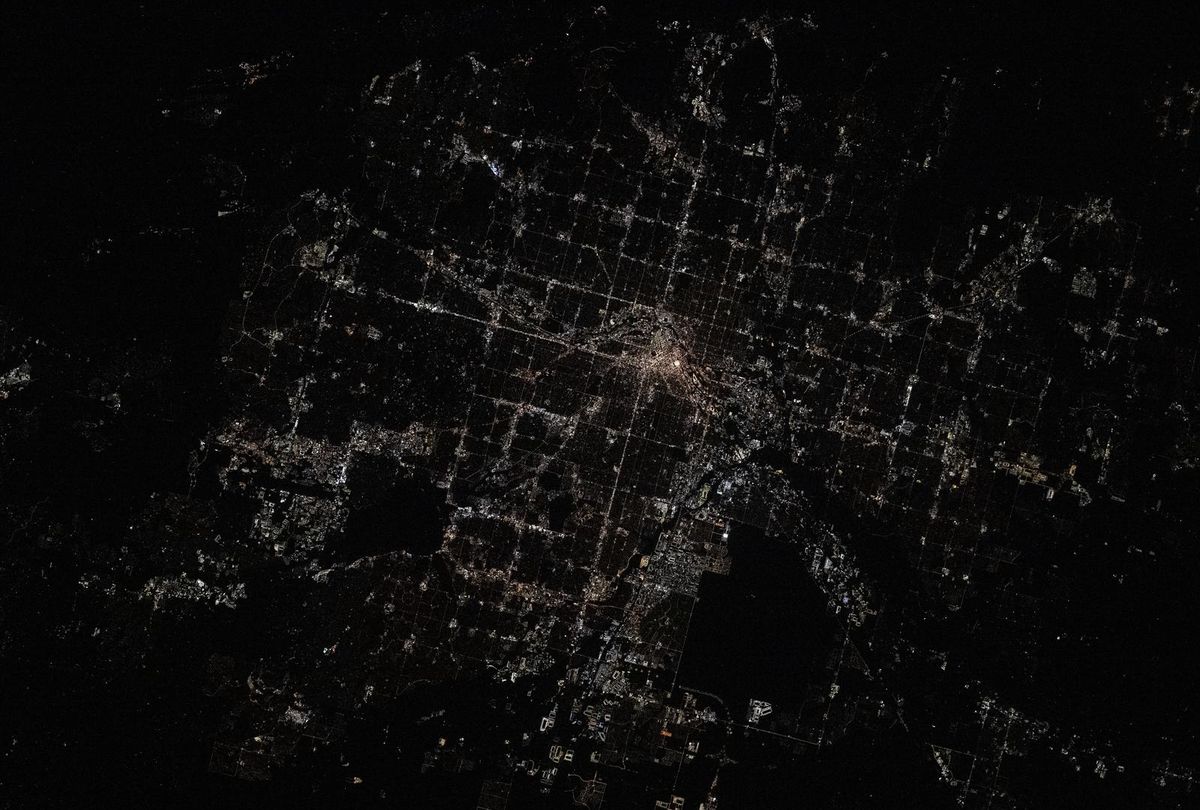 Denver at night from the International Space Station in June 2025, the downtown core bright and the grid fading into the dark plains to the east