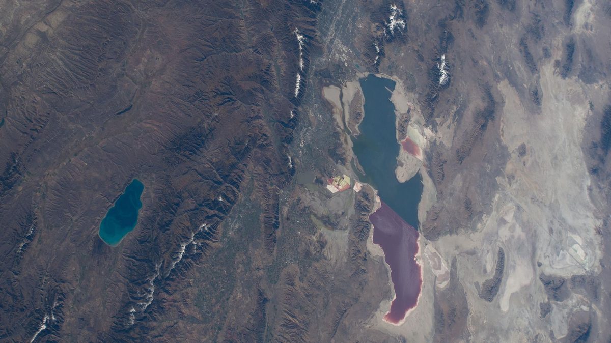 The Great Salt Lake, its northern arm red and southern arm blue on either side of a railroad causeway, with Bear Lake to the north-east, from the International Space Station