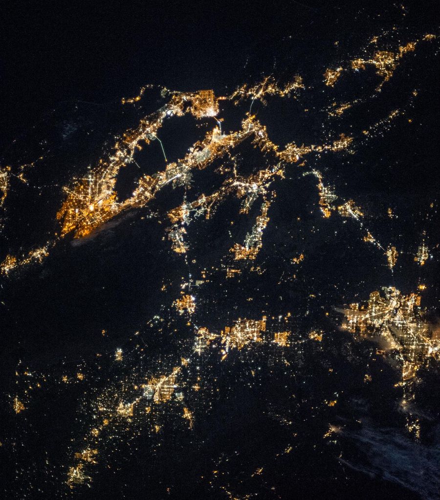 Northern California at night from the International Space Station, the Bay Area ring of light at upper left and the Central Valley cities trailing toward the dark Sierra