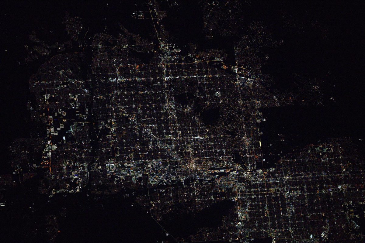 Metropolitan Phoenix at night from the International Space Station, the suburbs of Glendale, Scottsdale and Tempe spreading across the dark desert