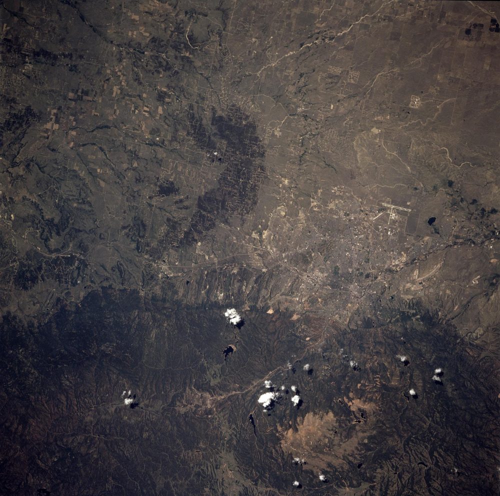 Colorado Springs on its mesa at the eastern base of Pikes Peak, photographed from the Space Shuttle Columbia