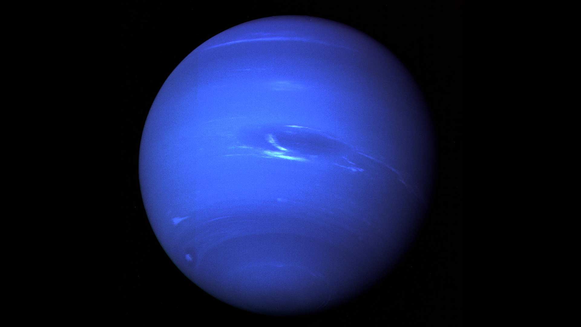 Neptune — the deep azure outermost planet showing cloud bands and the Great Dark Spot from Voyager 2's historic 1989 encounter