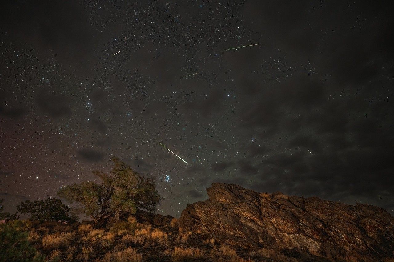 Perseid meteors streak across the night sky above Inyo National Forest near Bishop, California, during the 2024 Perseid shower peak. The Andromeda Galaxy is visible at the top of the frame.