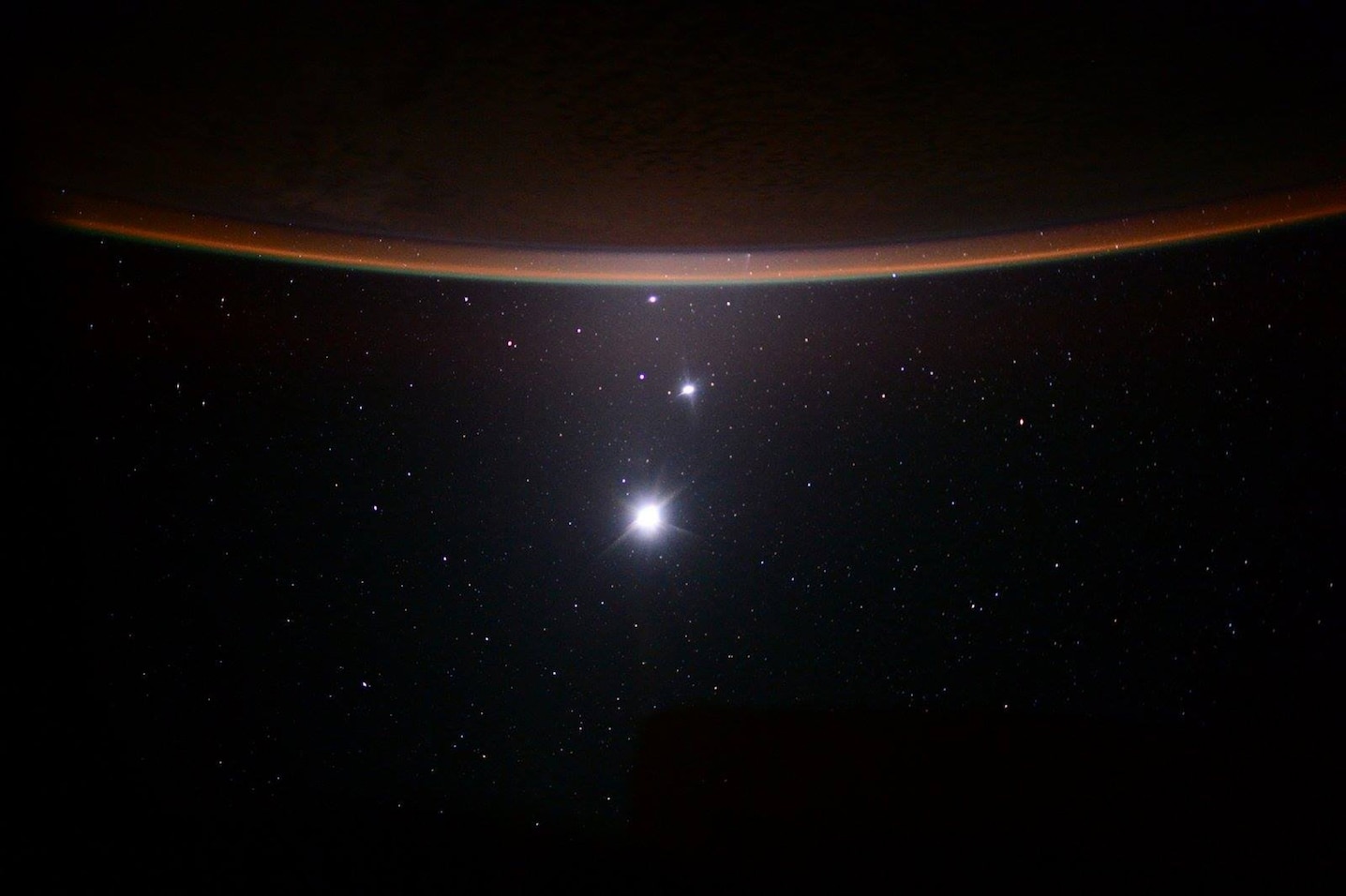 Crescent Earth above the Moon, Venus and Jupiter aligned in space — photographed from the International Space Station by NASA astronaut Scott Kelly, July 19, 2015