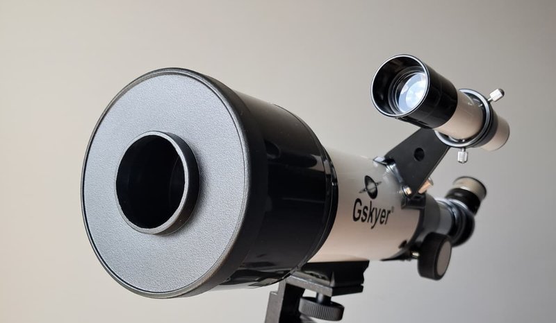 Close-up of the Gskyer 70mm AZ Refractor's objective lens and dew shield — the fully coated achromatic doublet that gathers light for lunar and planetary views
